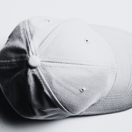Minimalist black and white cap from essence of i, designed for intentional, everyday wear with a clean, modern aesthetic.
